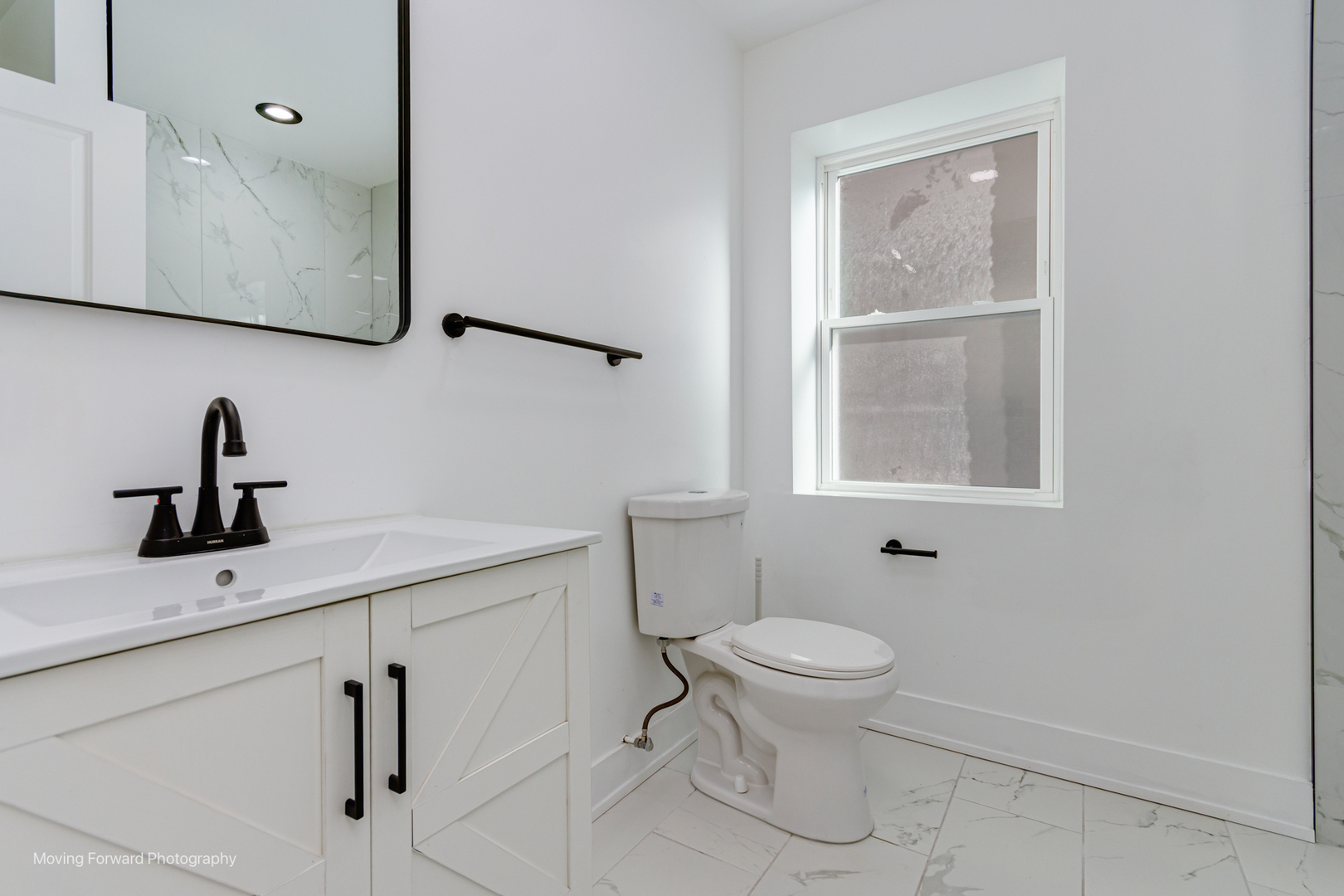 4941 West Iowa Street Chicago, IL 60651 - Photo 36 of 44 a bathroom with a toilet sink and mirror