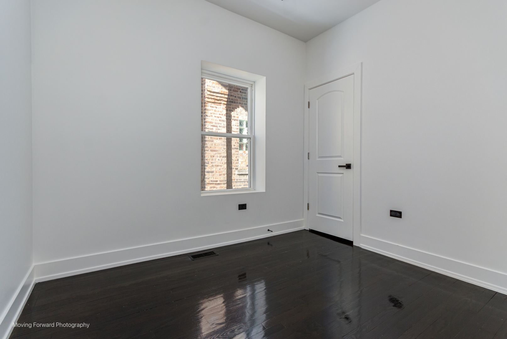 4941 West Iowa Street Chicago, IL 60651 - Photo 40 of 44 an empty room with wooden floor and windows