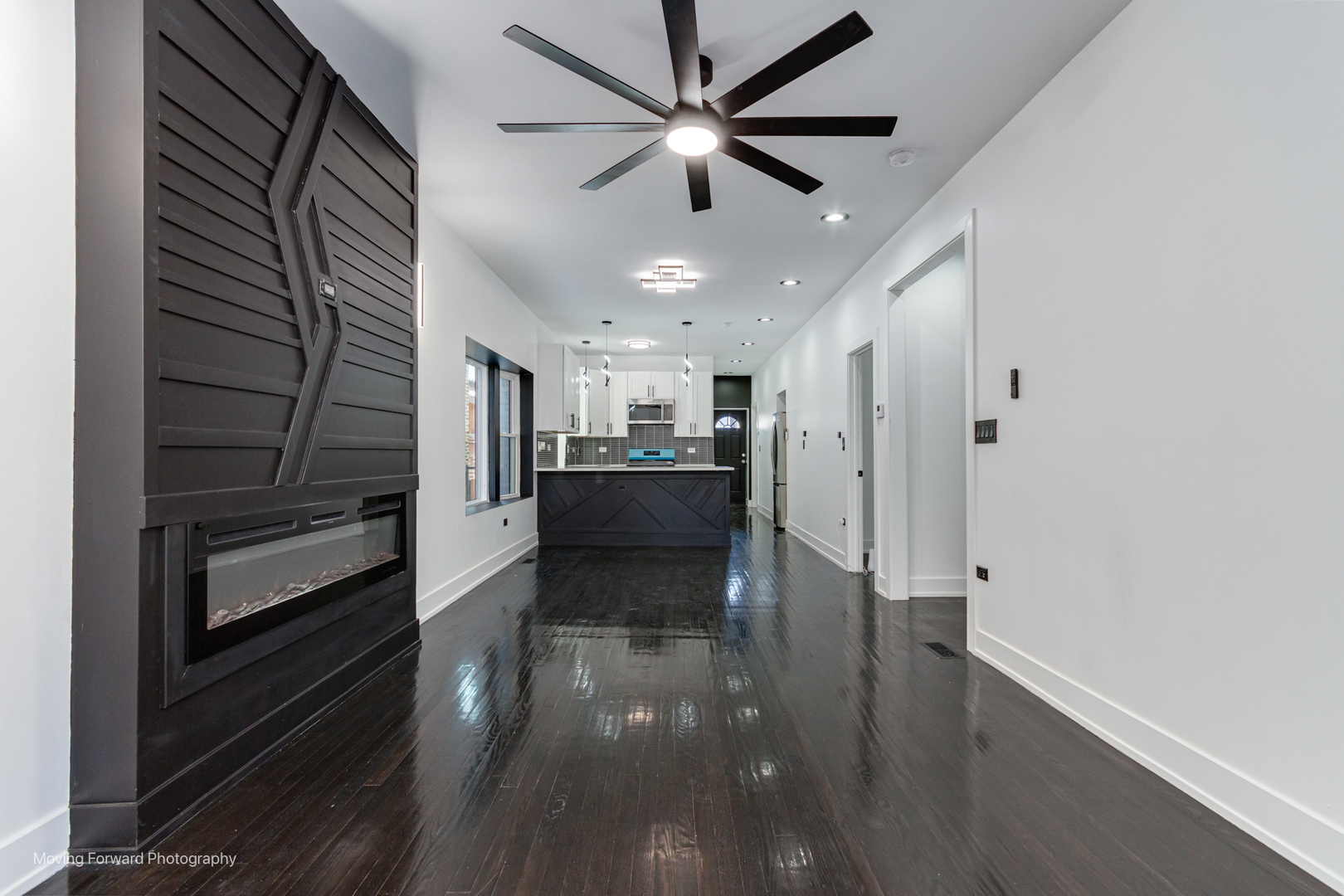 4941 West Iowa Street Chicago, IL 60651 - Photo 7 of 44 a view of a hallway with wooden floor and a kitchen