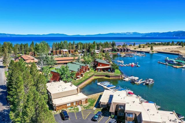 a view of a city with lots of trees and front view of a lake