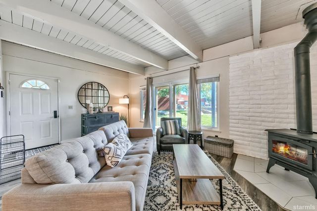 a living room with furniture wooden floor and a fireplace