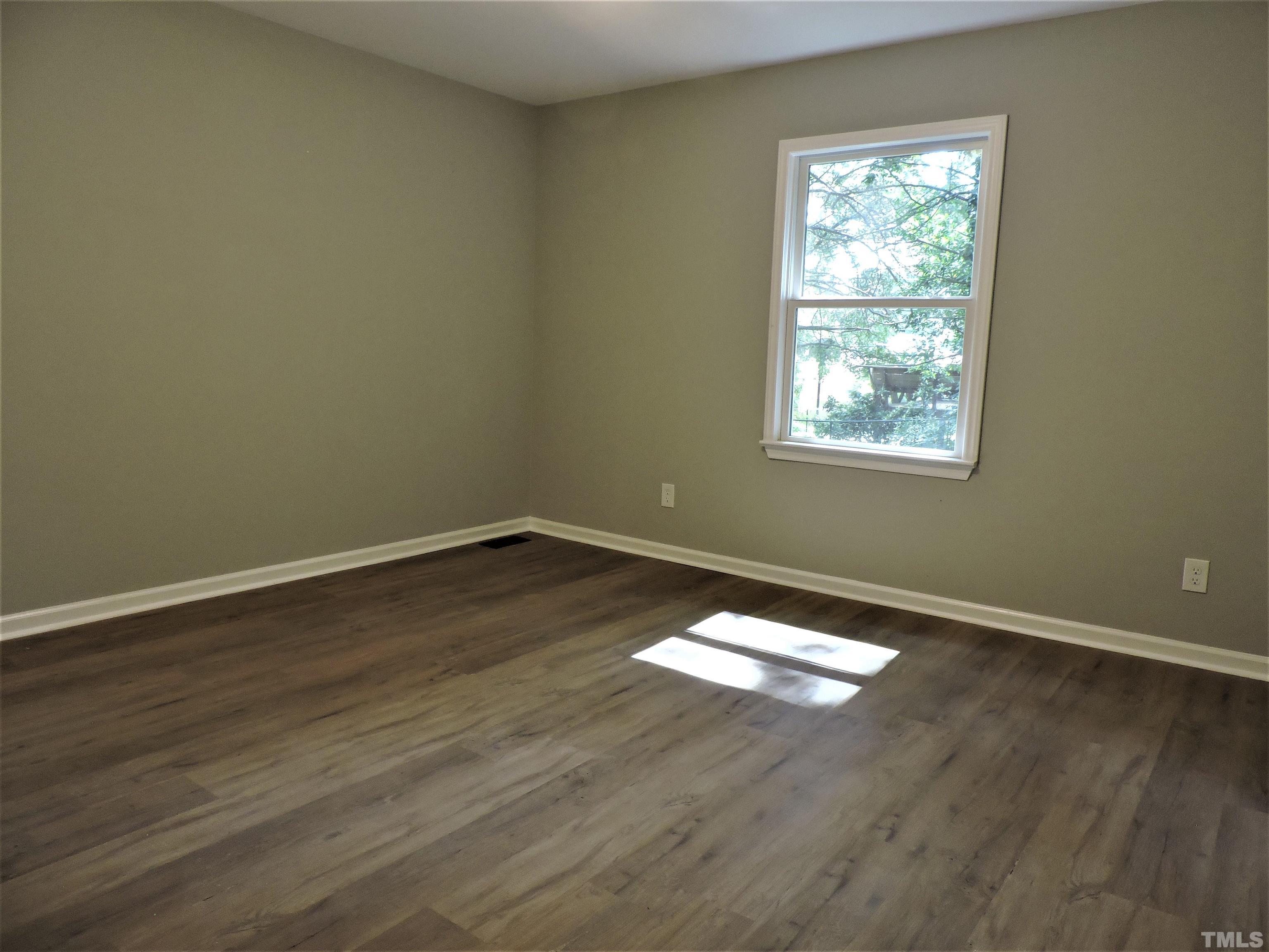 1513 Ridge Lane Hillsborough, NC 27278 - Photo 12 of 24 an empty room with wooden floor and windows