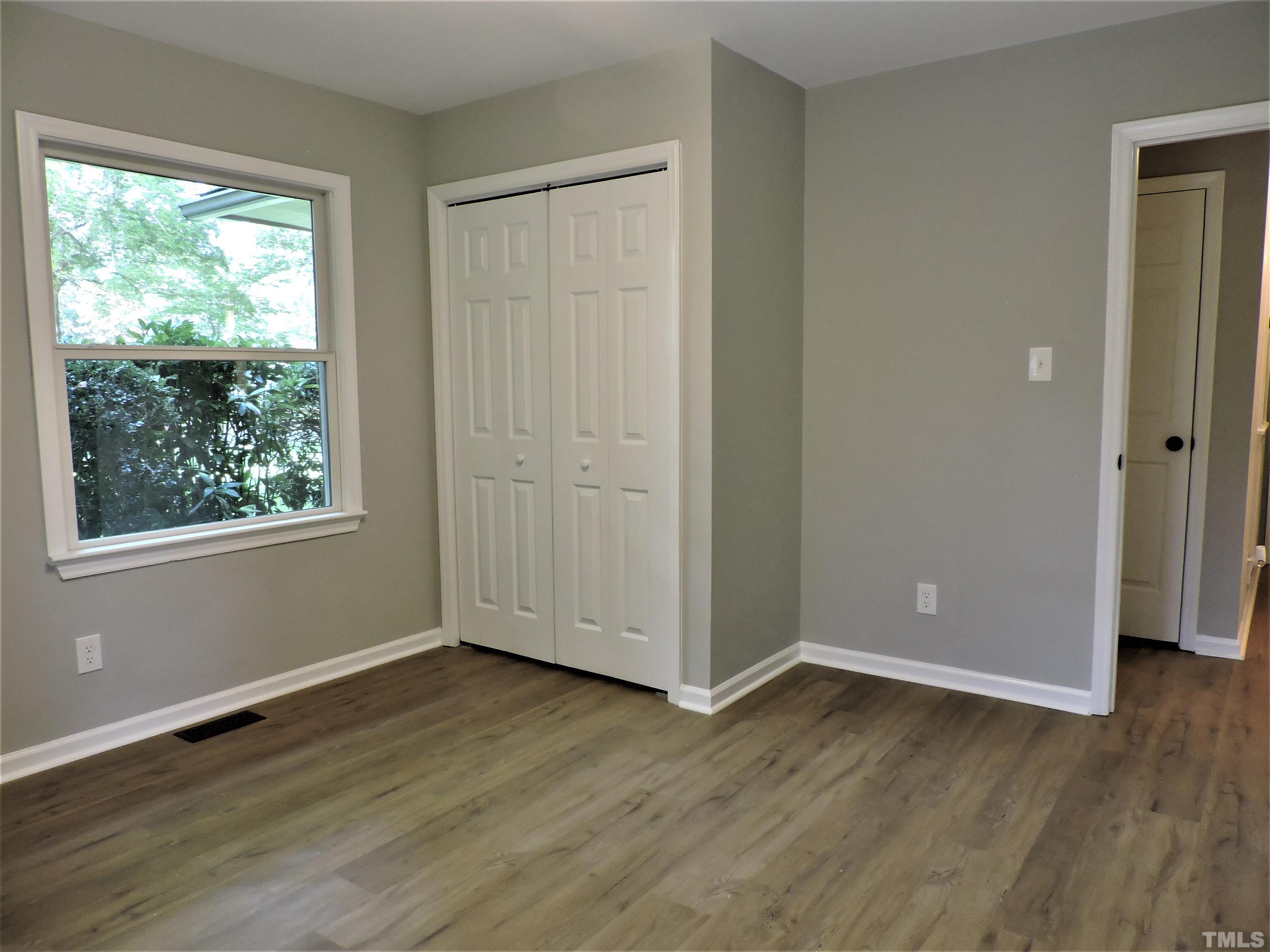 1513 Ridge Lane Hillsborough, NC 27278 - Photo 15 of 24 an empty room with wooden floor and windows