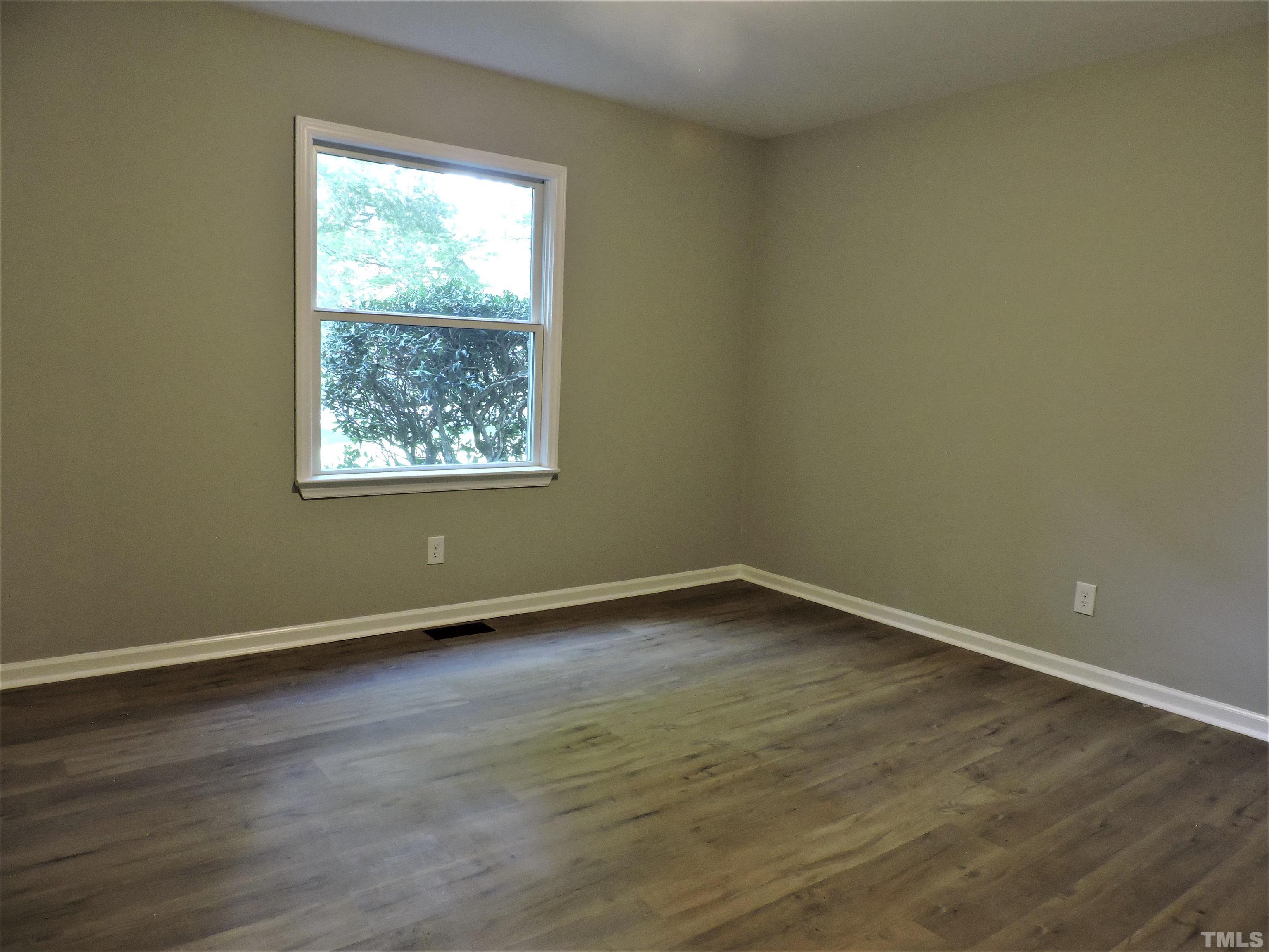1513 Ridge Lane Hillsborough, NC 27278 - Photo 16 of 24 an empty room with wooden floor and windows