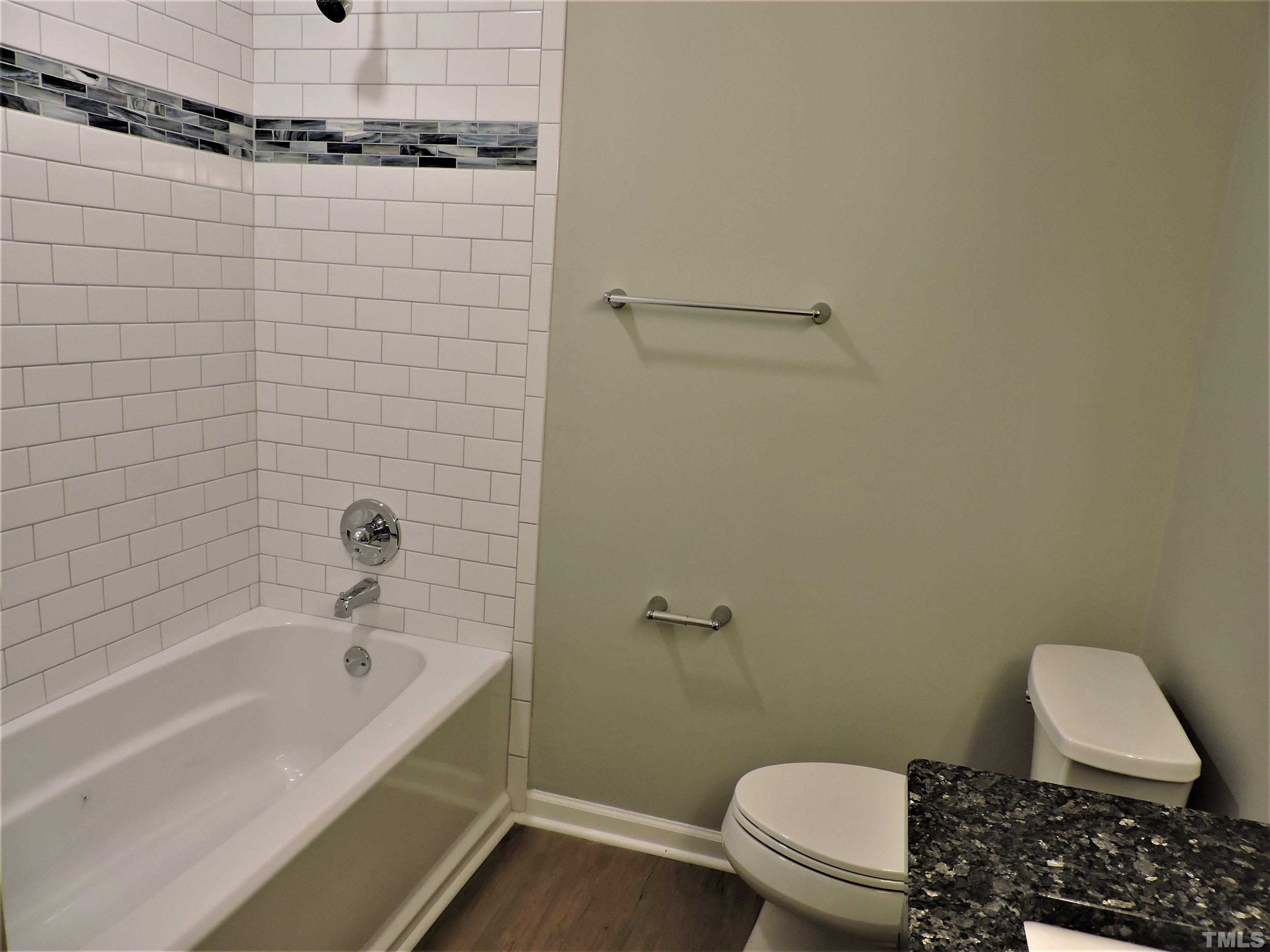 1513 Ridge Lane Hillsborough, NC 27278 - Photo 20 of 24 a bathroom with a toilet and a bathtub