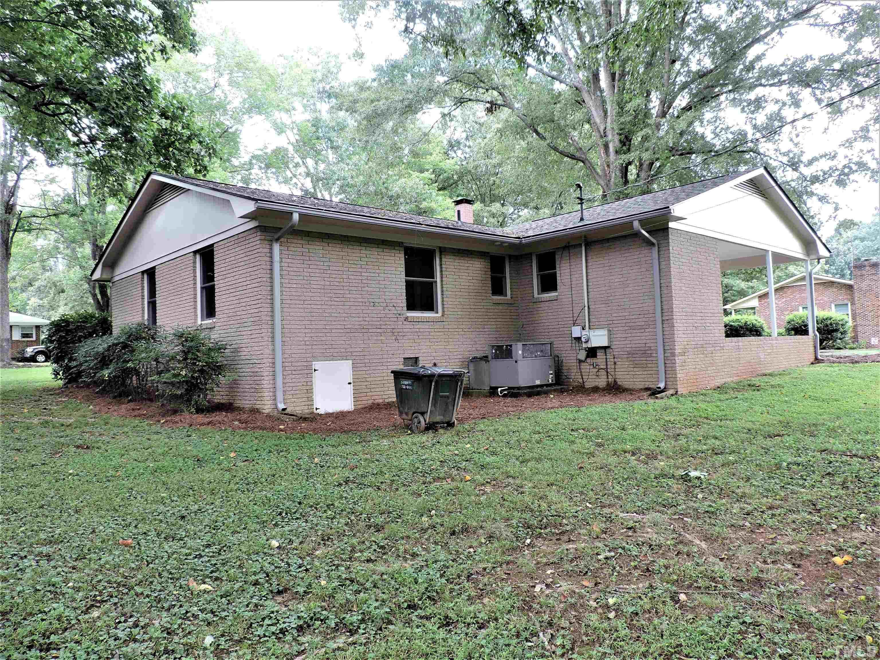 1513 Ridge Lane Hillsborough, NC 27278 - Photo 5 of 24 a backyard of a house with table and chairs