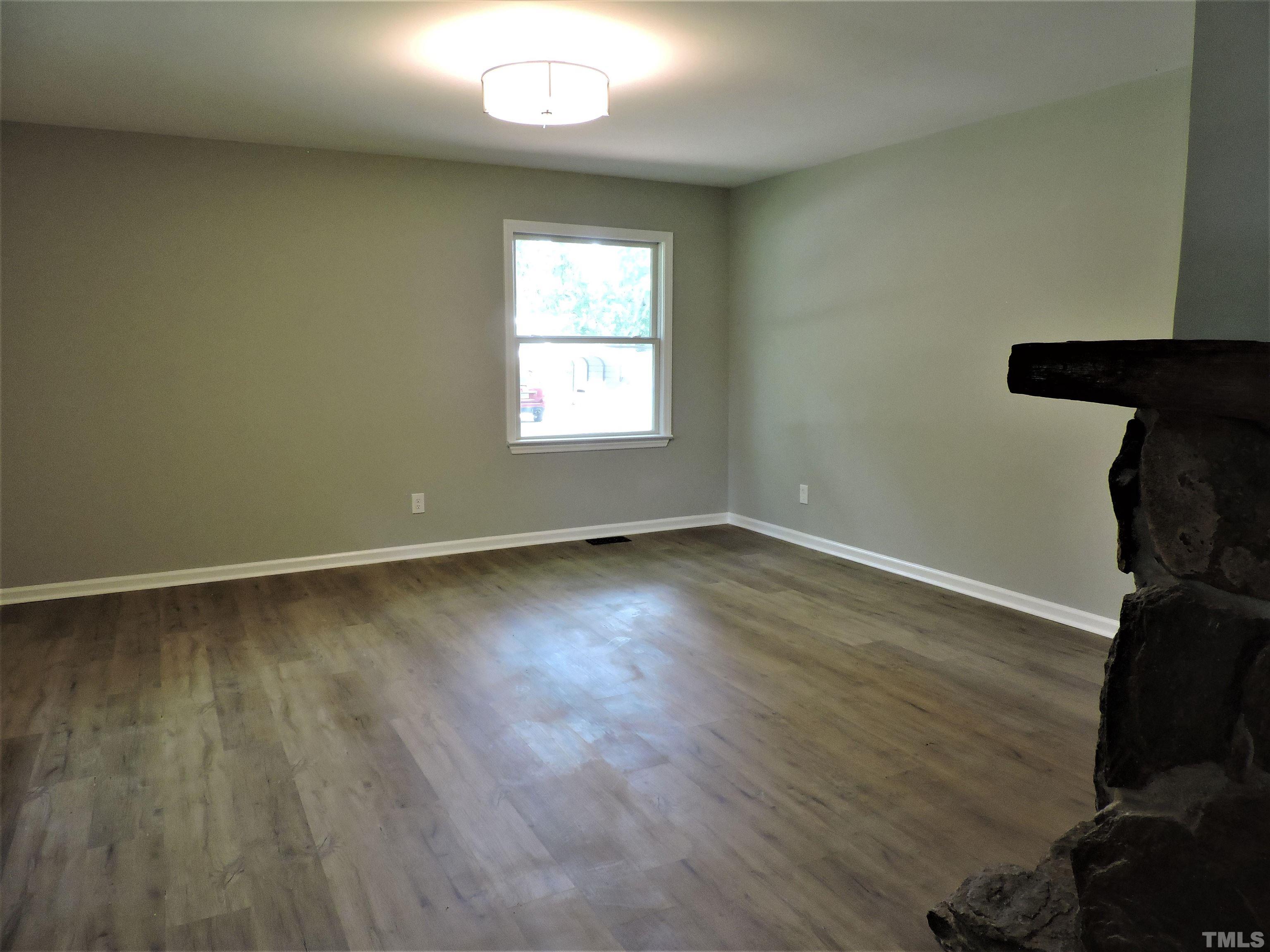 1513 Ridge Lane Hillsborough, NC 27278 - Photo 7 of 24 an empty room with wooden floor and windows