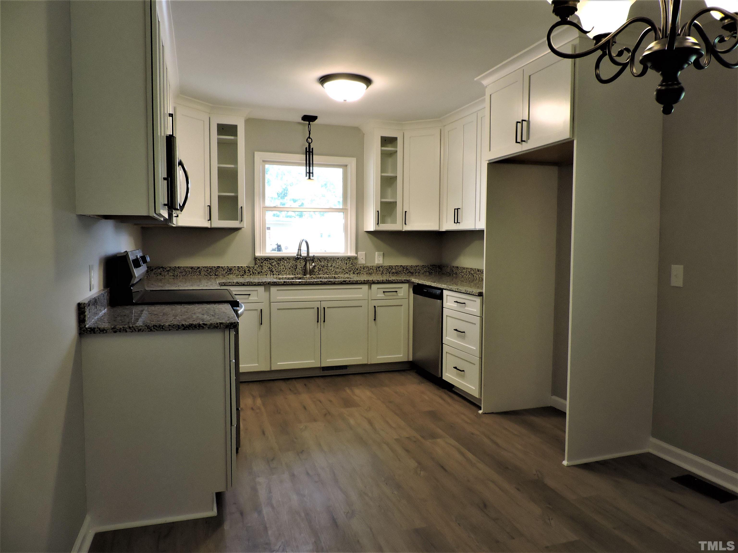 1513 Ridge Lane Hillsborough, NC 27278 - Photo 9 of 24 a kitchen with stainless steel appliances granite countertop a sink cabinets and wooden floor
