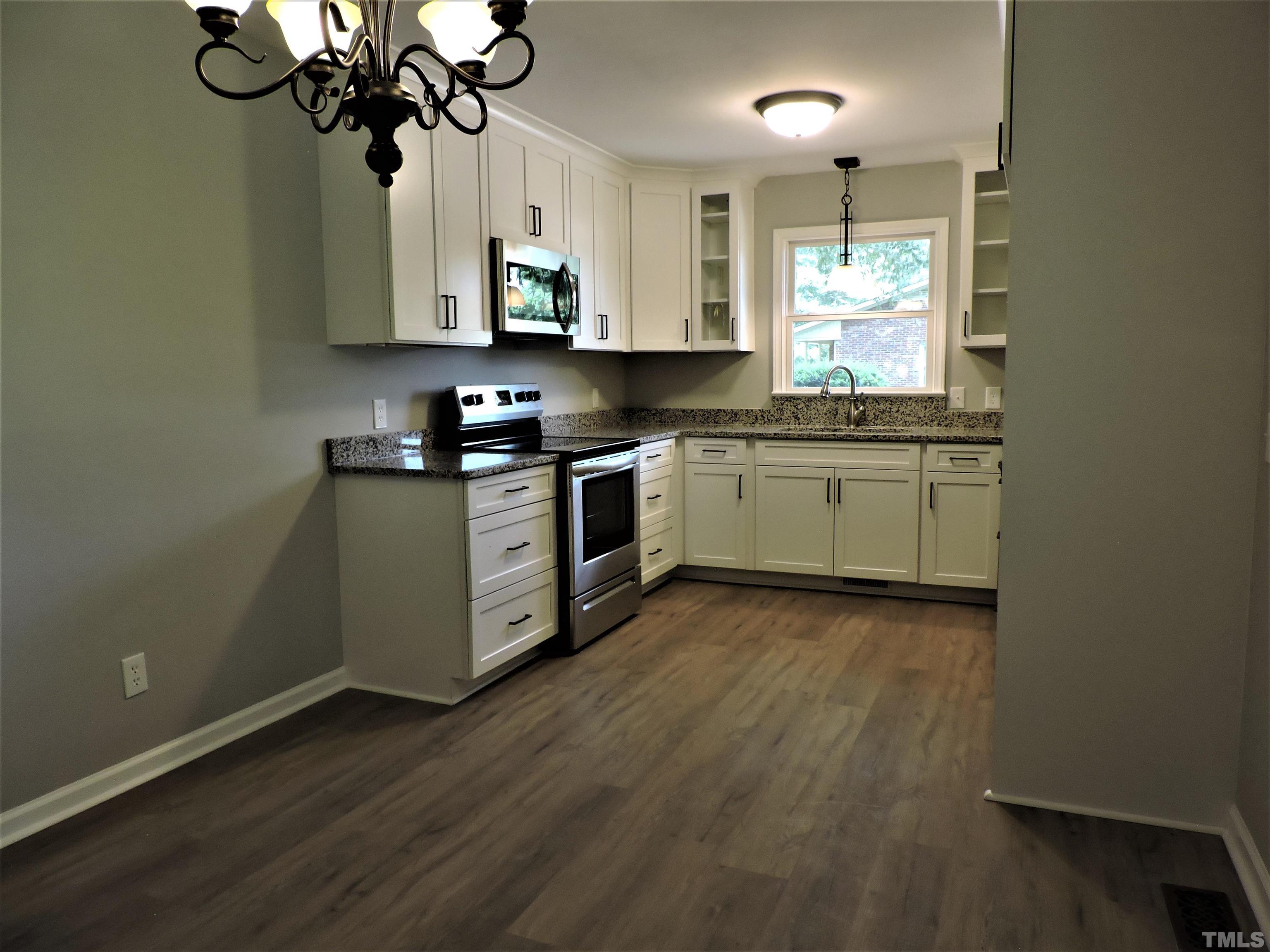 1513 Ridge Lane Hillsborough, NC 27278 - Photo 10 of 24 a kitchen with stainless steel appliances granite countertop a sink a stove top oven a counter space and cabinets