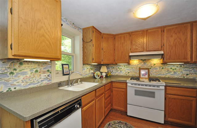 527 North Sheridan Road Waukegan, IL 60085 - Photo 7 of 25 a kitchen with a sink stove and cabinets