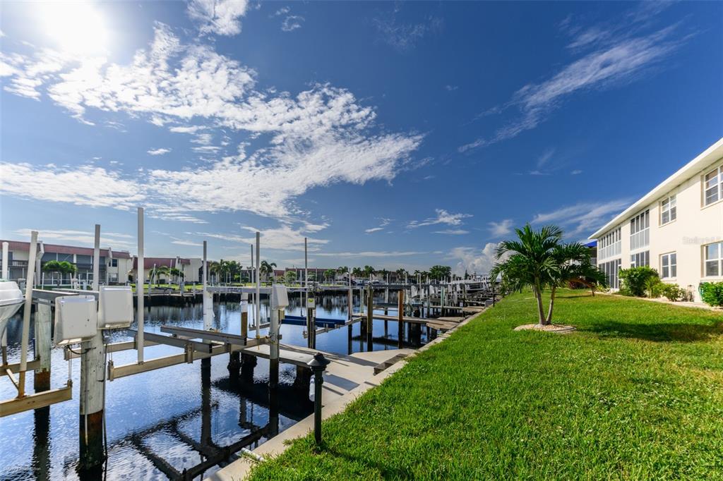 220 Coldeway Drive, Unit 112 Punta Gorda, FL 33950 - Photo 1 of 49 a view of a chairs and table in patio with a yard