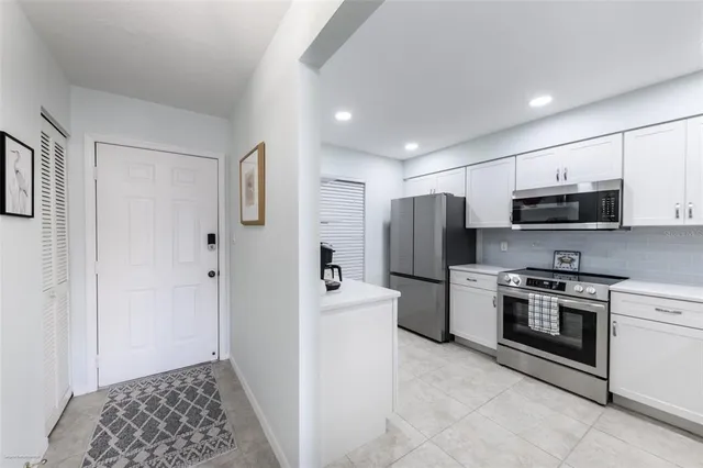 a kitchen with a refrigerator stove and microwave