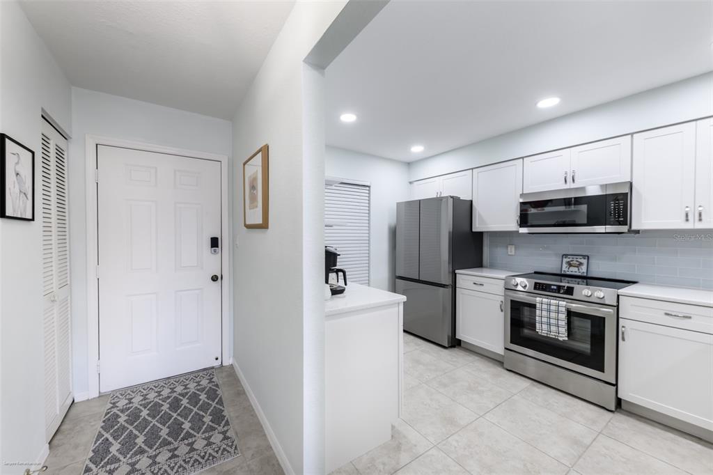220 Coldeway Drive, Unit 112 Punta Gorda, FL 33950 - Photo 11 of 49 a kitchen with a refrigerator stove and microwave