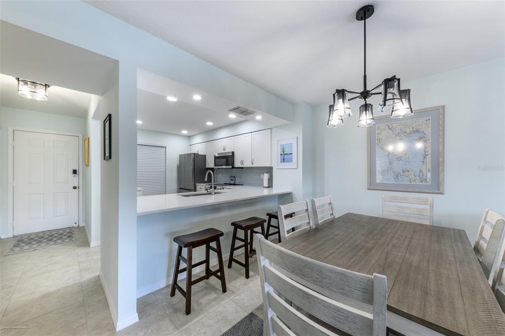 220 Coldeway Drive, Unit 112 Punta Gorda, FL 33950 - Photo 12 of 49 a view of a dining room and livingroom with furniture wooden floor a chandelier