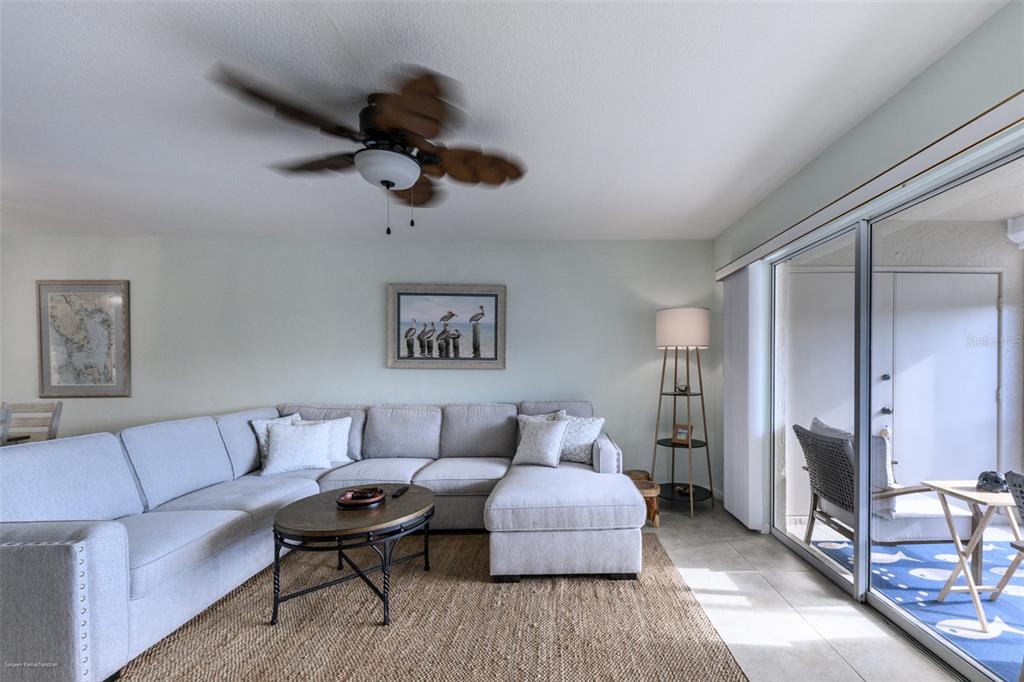 220 Coldeway Drive, Unit 112 Punta Gorda, FL 33950 - Photo 21 of 49 a living room with furniture and a wooden floor