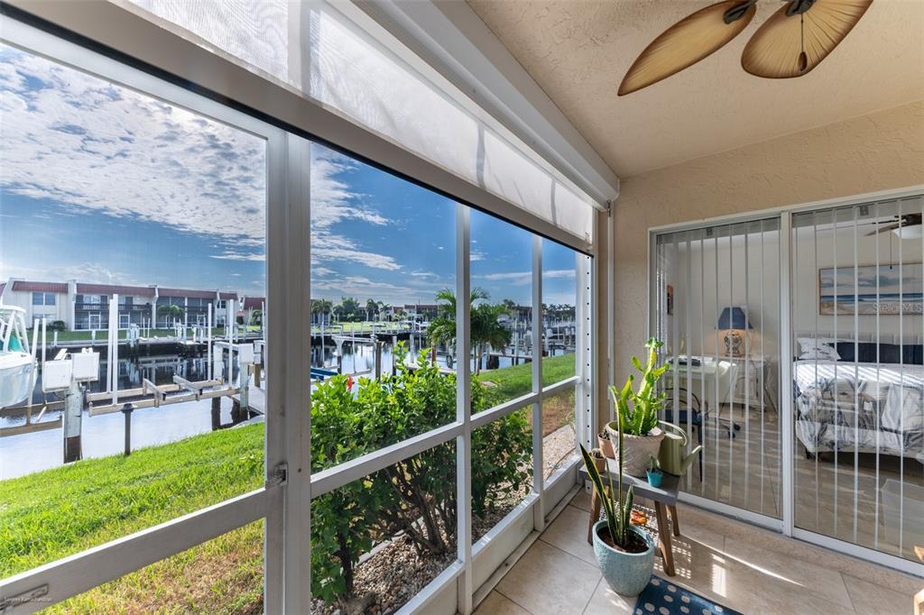 220 Coldeway Drive, Unit 112 Punta Gorda, FL 33950 - Photo 24 of 49 a view of a porch and patio with table and chairs