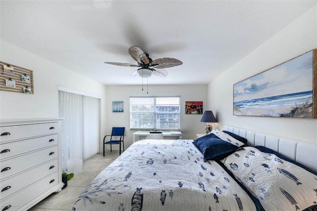 220 Coldeway Drive, Unit 112 Punta Gorda, FL 33950 - Photo 26 of 49 a bed room with a bed and a dresser