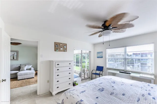 a bedroom with a bed a window and a dresser