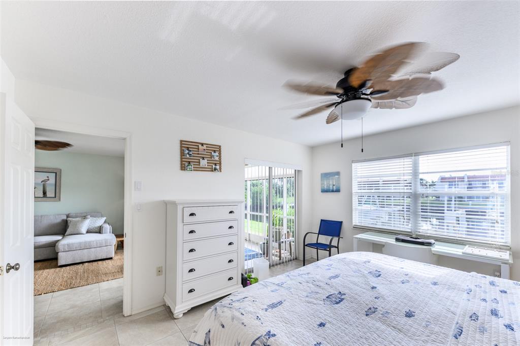 220 Coldeway Drive, Unit 112 Punta Gorda, FL 33950 - Photo 27 of 49 a bedroom with a bed a window and a dresser