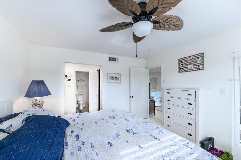 220 Coldeway Drive, Unit 112 Punta Gorda, FL 33950 - Photo 29 of 49 a bedroom with a bed and a dresser