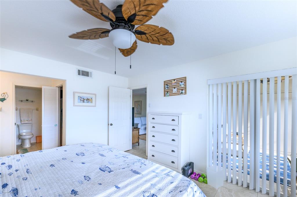 220 Coldeway Drive, Unit 112 Punta Gorda, FL 33950 - Photo 30 of 49 a bedroom with a bed and a chandelier