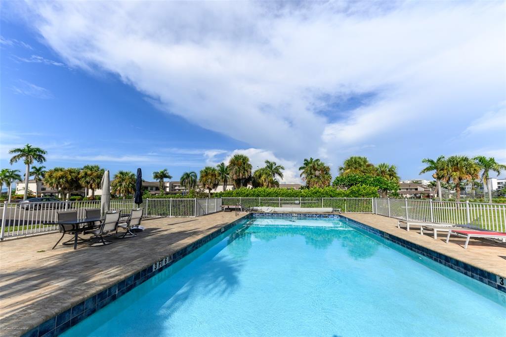 220 Coldeway Drive, Unit 112 Punta Gorda, FL 33950 - Photo 3 of 49 a view of a swimming pool with a yard and sitting area