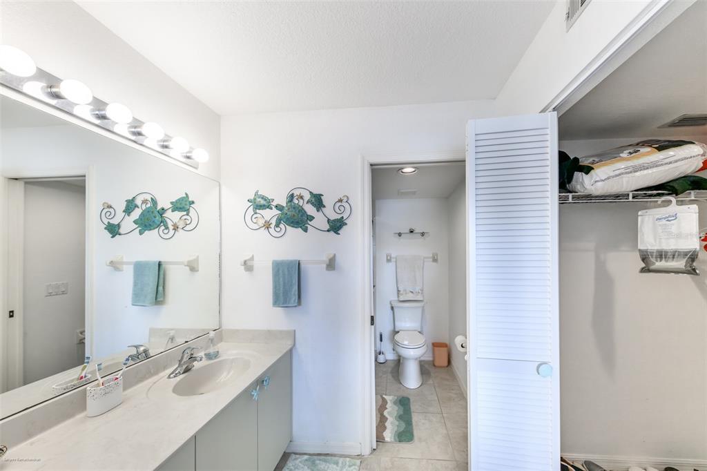 220 Coldeway Drive, Unit 112 Punta Gorda, FL 33950 - Photo 32 of 49 a bathroom with a sink vanity mirror and toilet