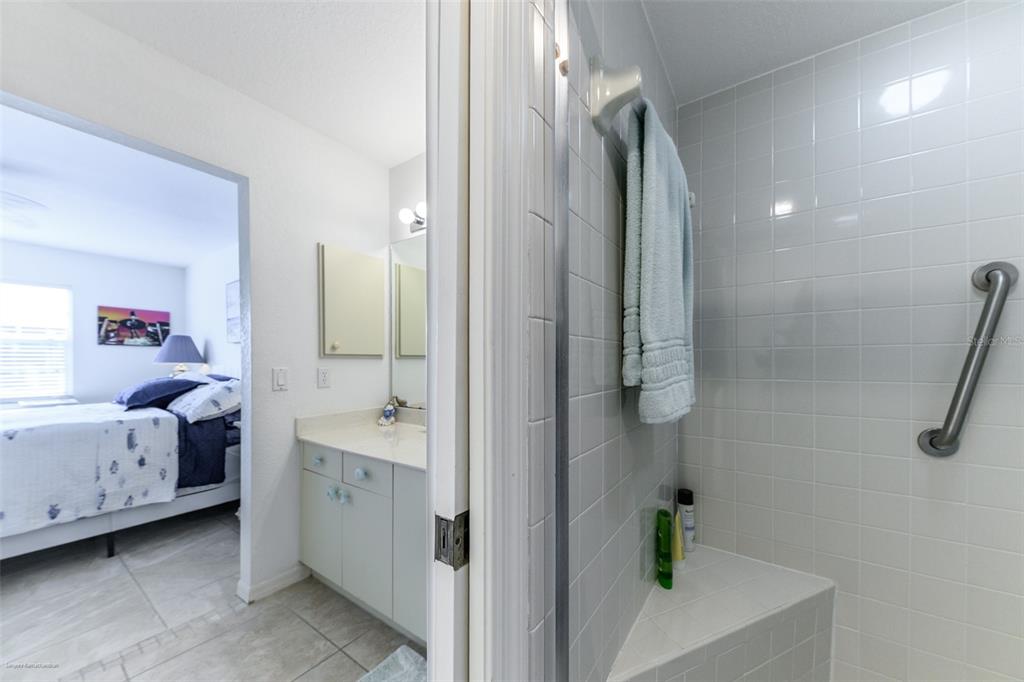 220 Coldeway Drive, Unit 112 Punta Gorda, FL 33950 - Photo 33 of 49 a bathroom with a sink a mirror and a shower