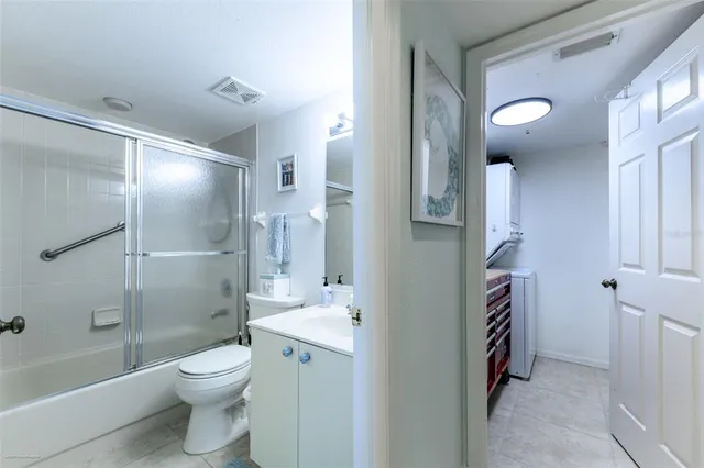 a bathroom with a toilet a sink and shower