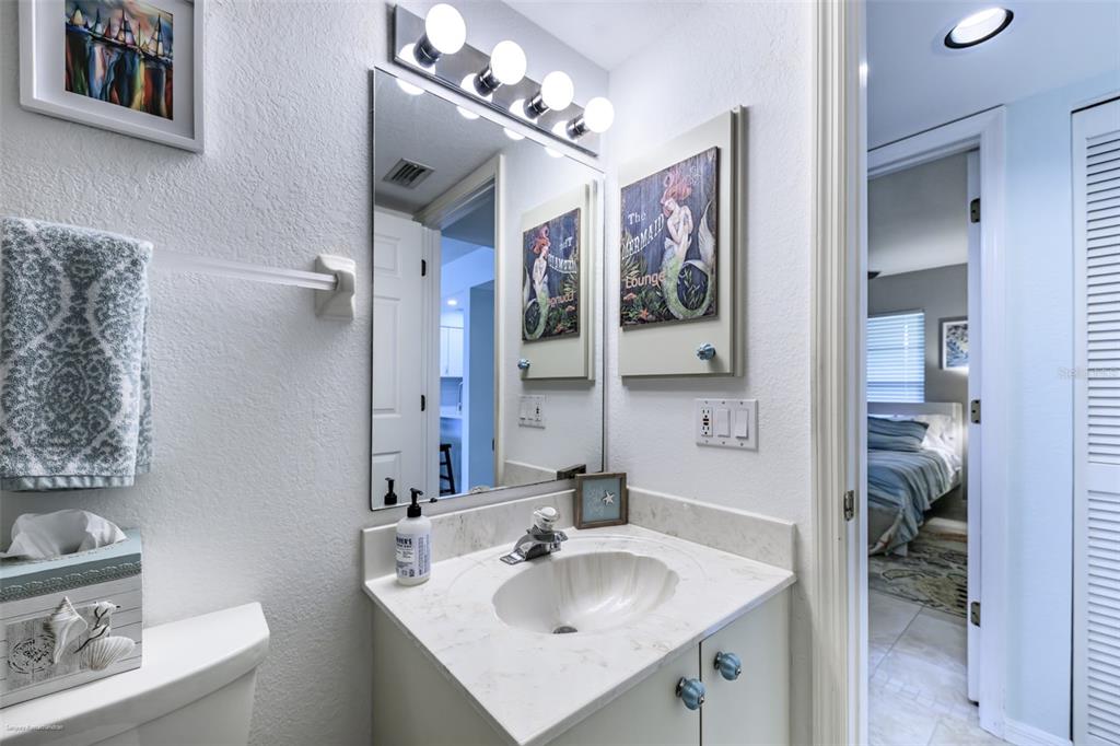 220 Coldeway Drive, Unit 112 Punta Gorda, FL 33950 - Photo 36 of 49 a bathroom with a sink vanity and a mirror