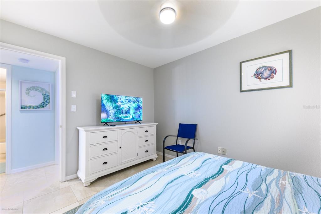 220 Coldeway Drive, Unit 112 Punta Gorda, FL 33950 - Photo 38 of 49 a bedroom with a bed and wooden floor