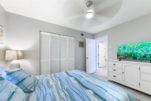 a bedroom with a large bed and a window