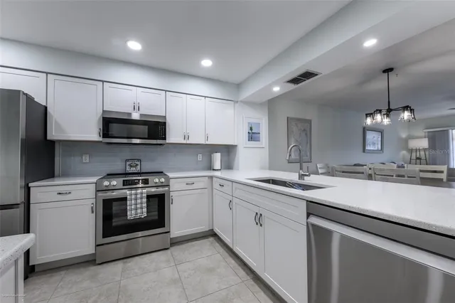 a kitchen with appliances cabinets and a sink