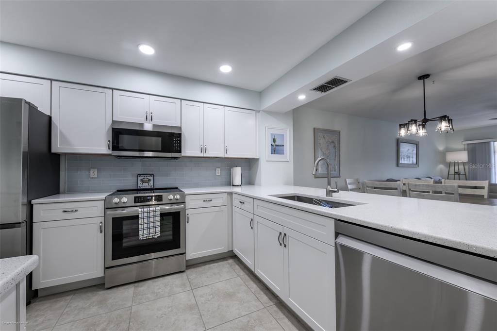 220 Coldeway Drive, Unit 112 Punta Gorda, FL 33950 - Photo 6 of 49 a kitchen with appliances cabinets and a sink