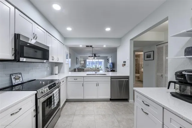 a kitchen with a sink stove oven and microwave