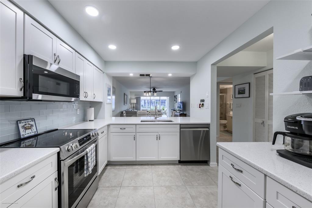 220 Coldeway Drive, Unit 112 Punta Gorda, FL 33950 - Photo 10 of 49 a kitchen with a sink stove oven and microwave