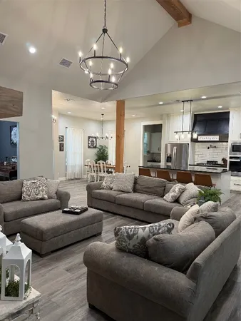 a living room with furniture and a chandelier