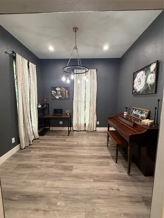 a living room with a table chairs and a chandelier