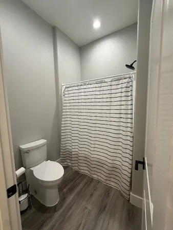 a bathroom with a toilet and a shower