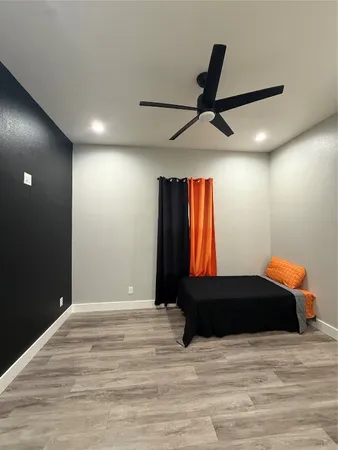 a bedroom with a bed and a ceiling fan