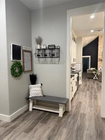 a hallway with a table and chairs