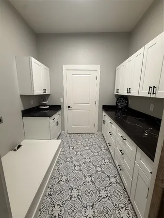 a kitchen with a sink a stove and cabinets