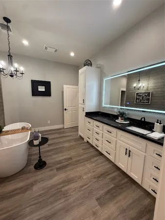 a spacious bathroom with a double vanity sink and a mirror