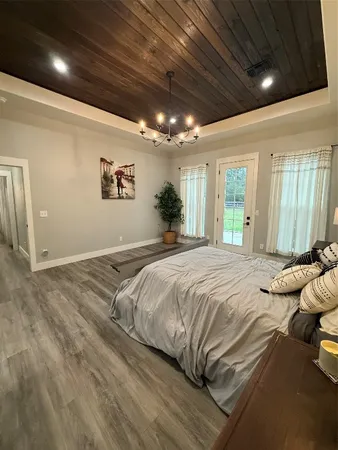 a spacious bedroom with a bed and a large window