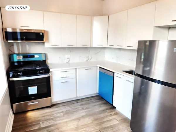 a kitchen with stainless steel appliances a refrigerator stove and microwave