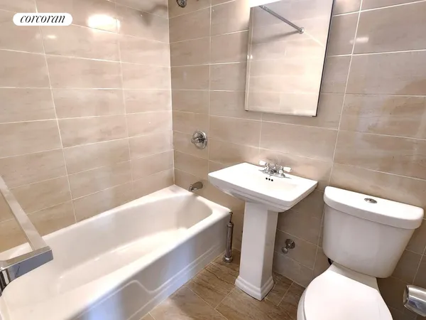 a bathroom with a sink mirror toilet and bathtub