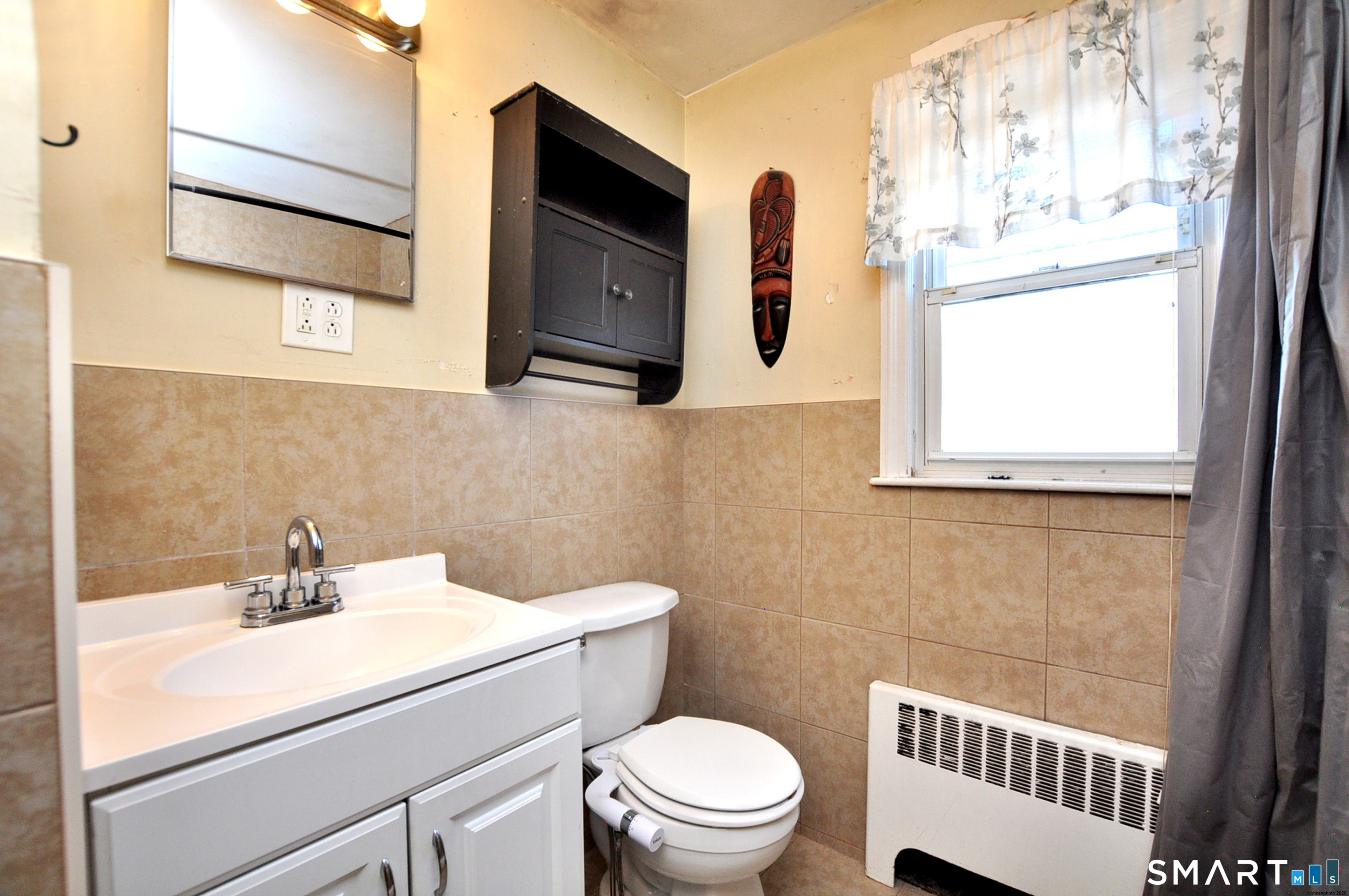 103 West Center Street Manchester, CT 06040 - Photo 19 of 29 a bathroom with a sink a toilet and a window