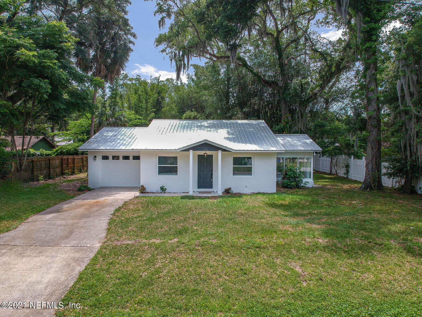 108 Linden Road St. Augustine, FL 32086 - Photo 1 of 36 a front view of a house with a garden