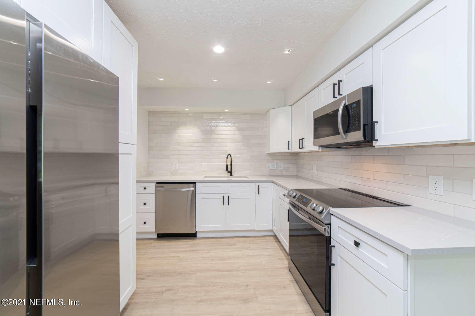 108 Linden Road St. Augustine, FL 32086 - Photo 11 of 36 a kitchen with a sink microwave and refrigerator