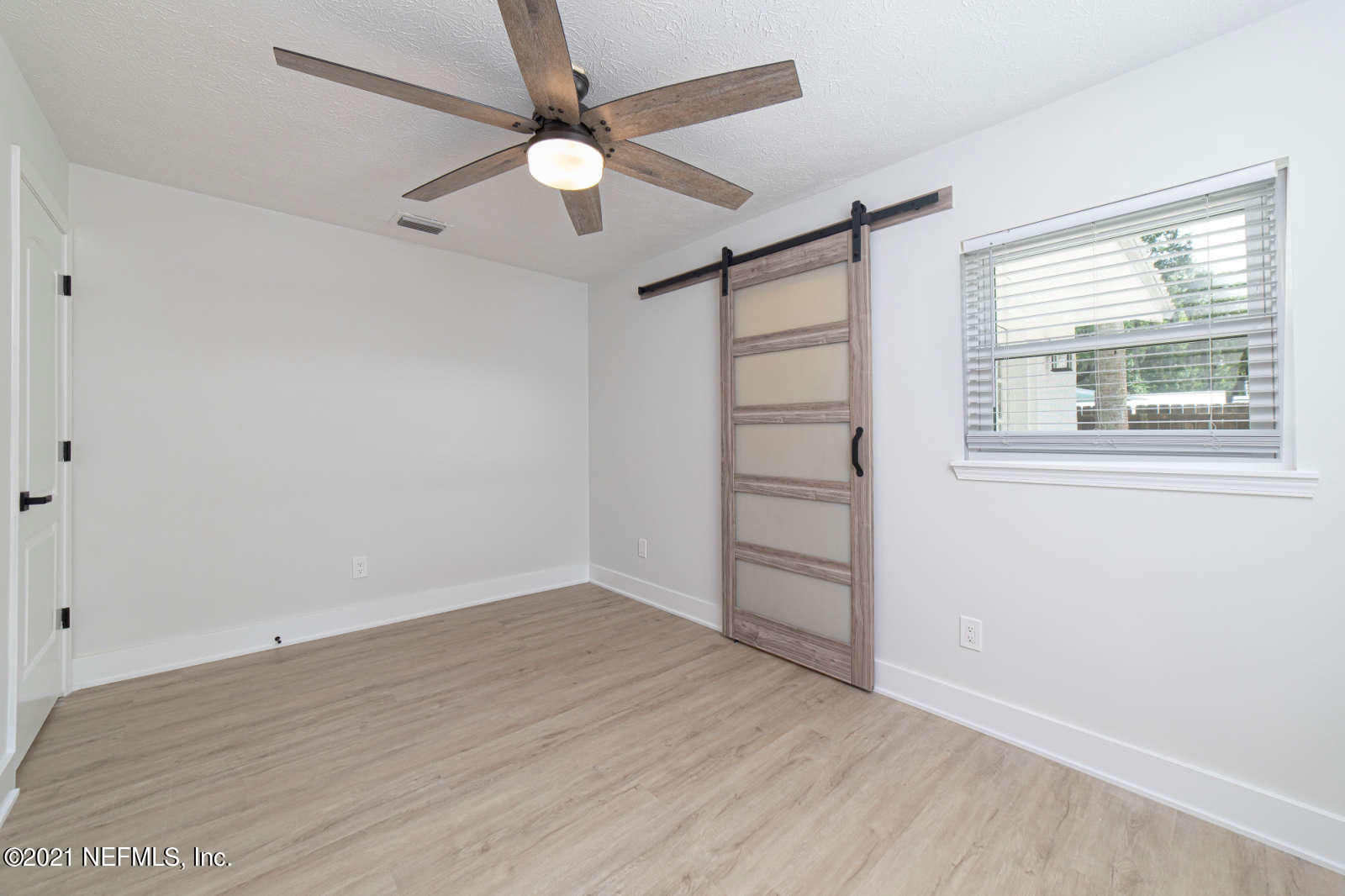 108 Linden Road St. Augustine, FL 32086 - Photo 23 of 36 an empty room with wooden floor fan and windows